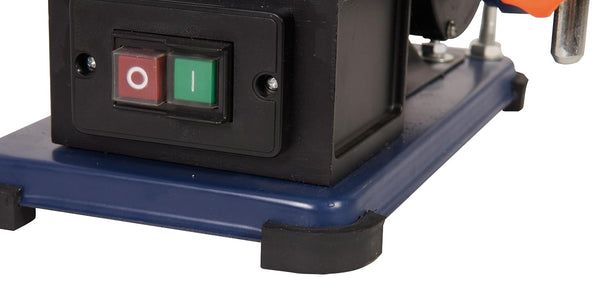Close-up of a machine with a red and green switch on a blue base.